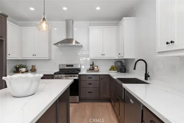 a kitchen with cabinets appliances and a sink