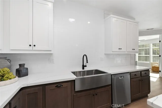 a kitchen with kitchen island a sink dining table and chairs