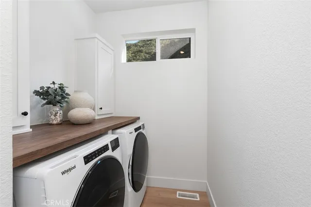 a view of a balcony with wooden floor and potted plants