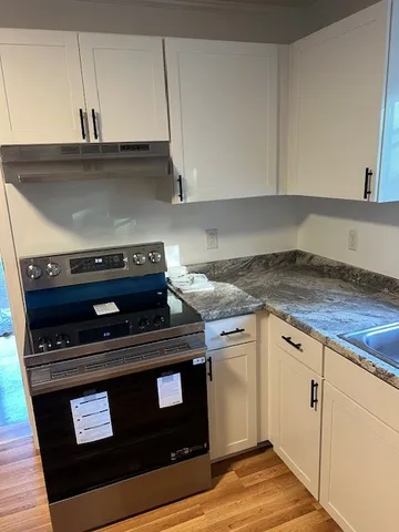 a kitchen with a sink stove and refrigerator