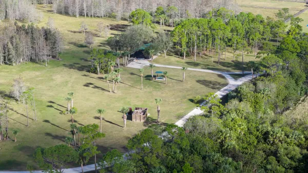 an aerial view of a house with a yard
