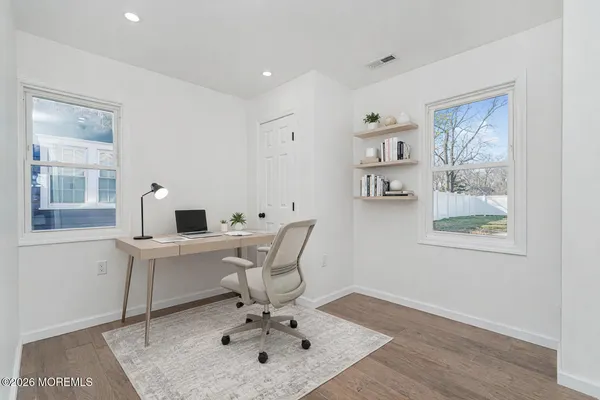 a bedroom with a bed and a night stand