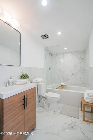 a bathroom with a sink toilet and shower