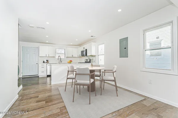 a kitchen with stainless steel appliances granite countertop a sink a stove a microwave a counter top space and cabinets