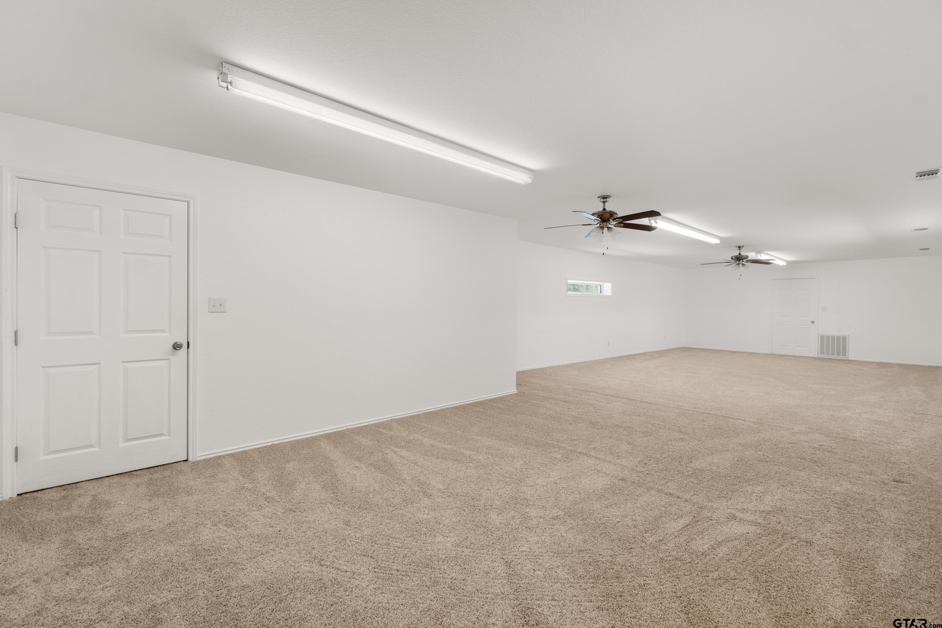 672 County Road 4960 Pittsburg, TX 75686 - Photo 25 of 26 en empty room with ceiling fan and window