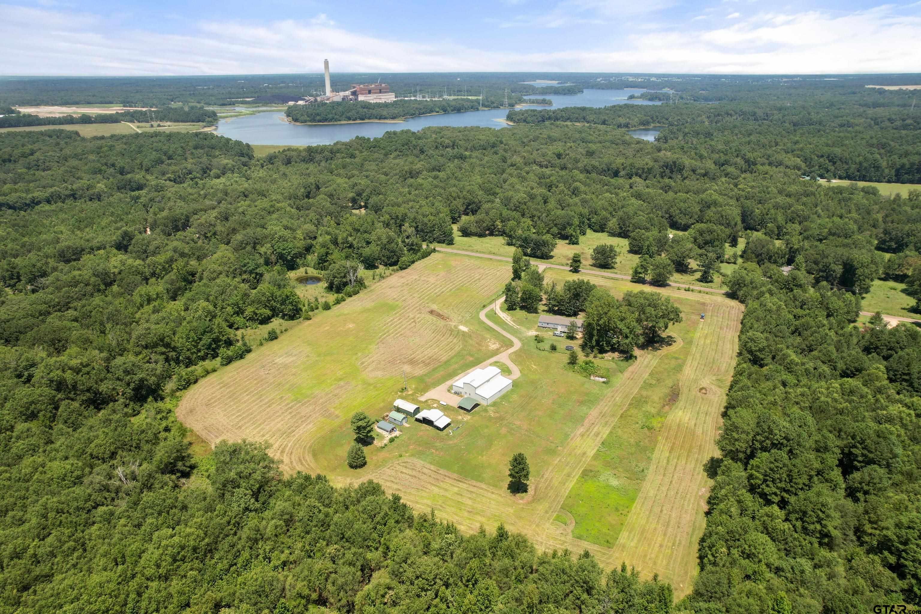 672 County Road 4960 Pittsburg, TX 75686 - Photo 3 of 26 a view of a swimming pool with a yard