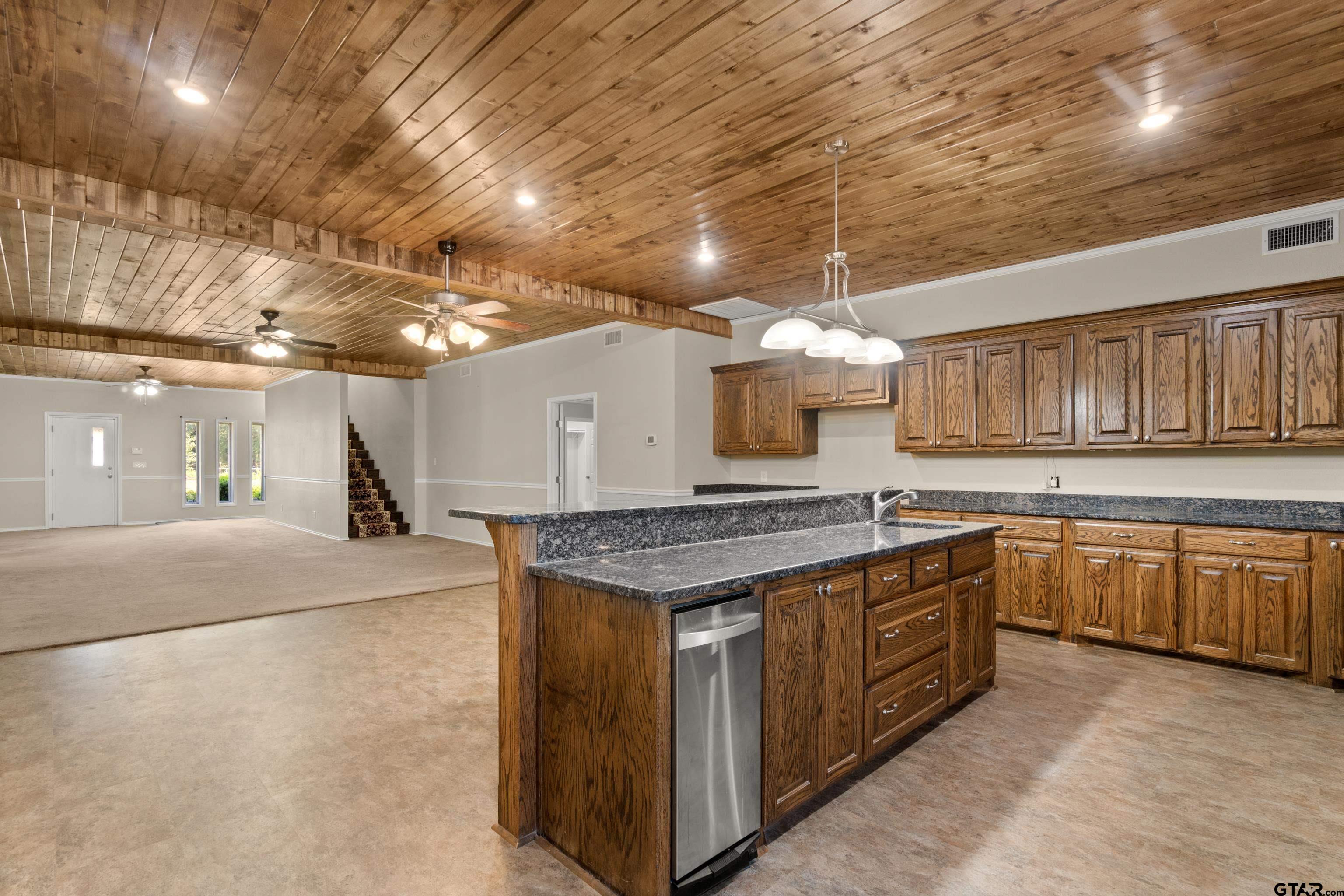 672 County Road 4960 Pittsburg, TX 75686 - Photo 6 of 26 a kitchen with stainless steel appliances granite countertop a stove a sink and a refrigerator