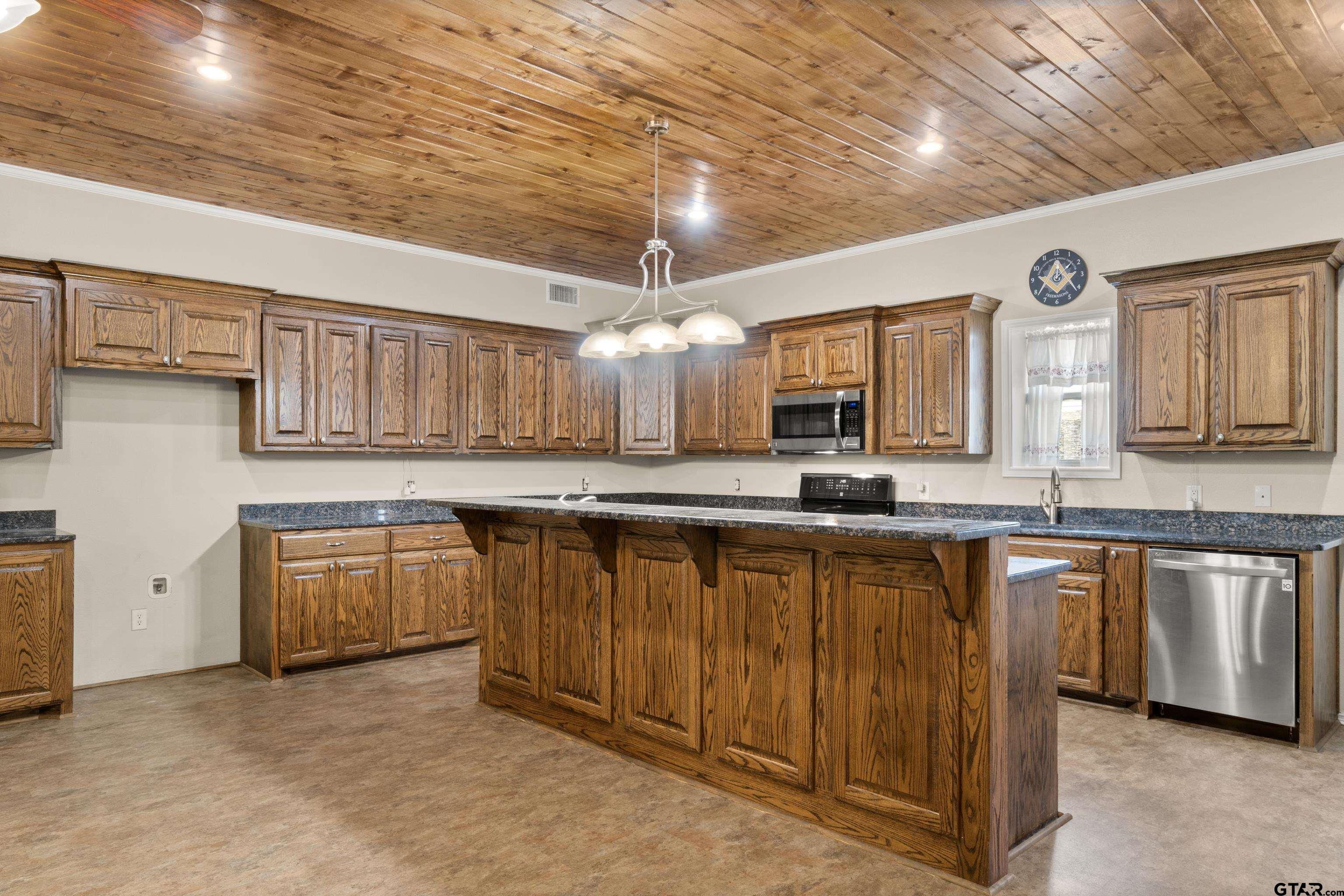 672 County Road 4960 Pittsburg, TX 75686 - Photo 7 of 26 a large kitchen with stainless steel appliances granite countertop a sink and cabinets