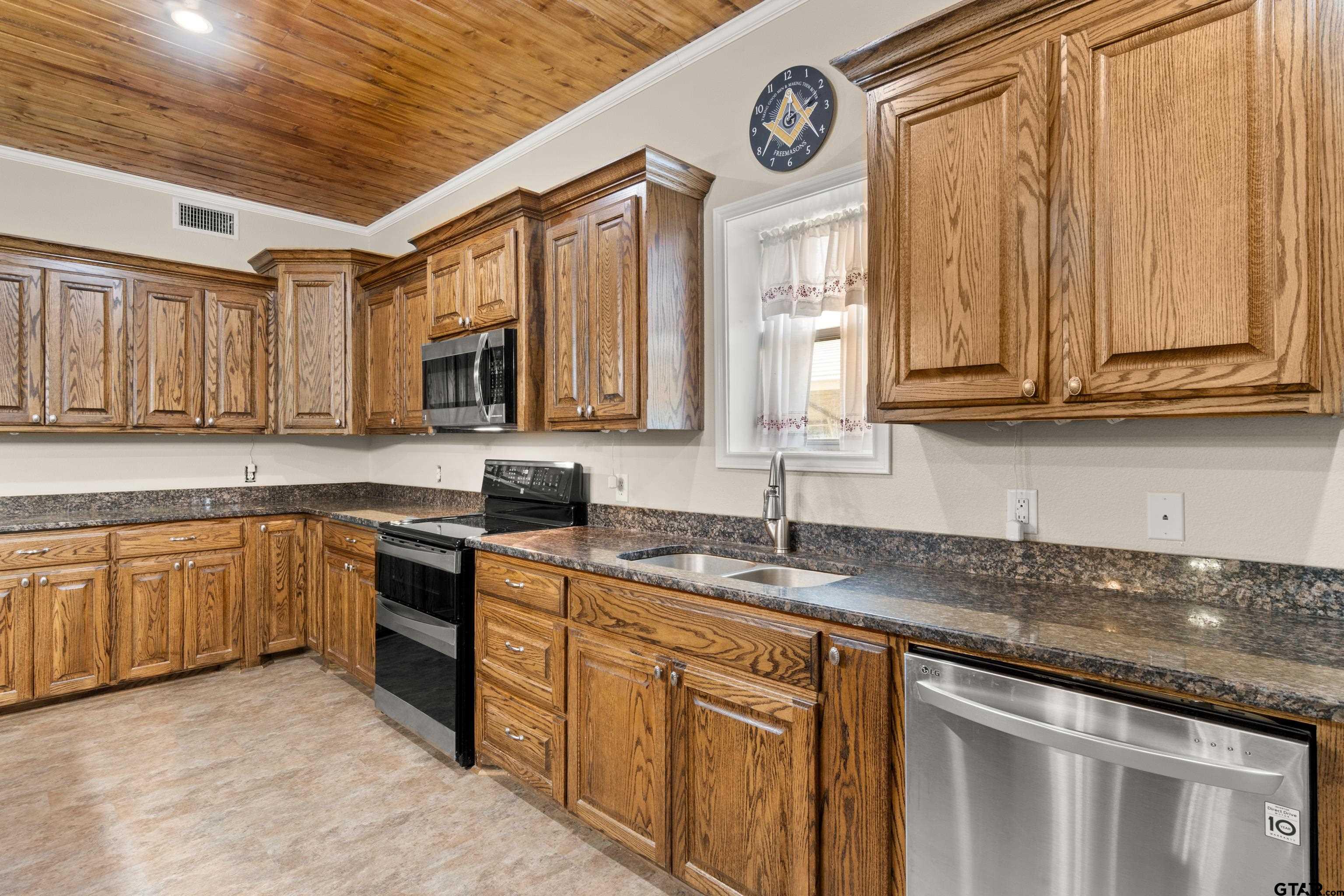 672 County Road 4960 Pittsburg, TX 75686 - Photo 10 of 26 a kitchen with stainless steel appliances granite countertop a sink and cabinets