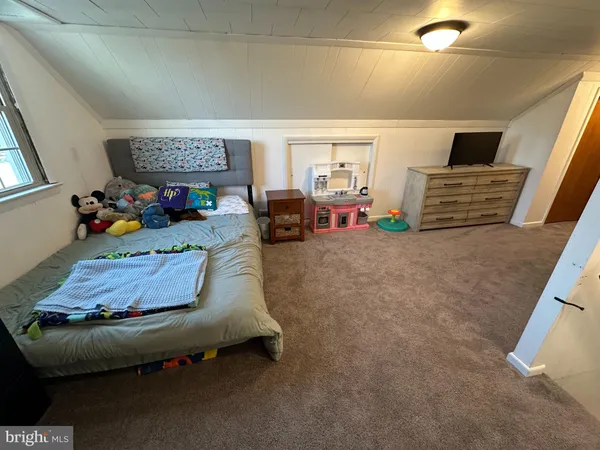 a bed room with furniture and a flat screen tv