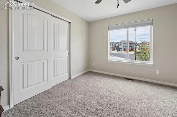 a bedroom that has a bed and a flat screen tv