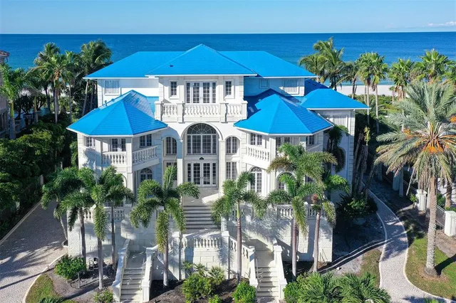a view of a patio with plants and palm trees