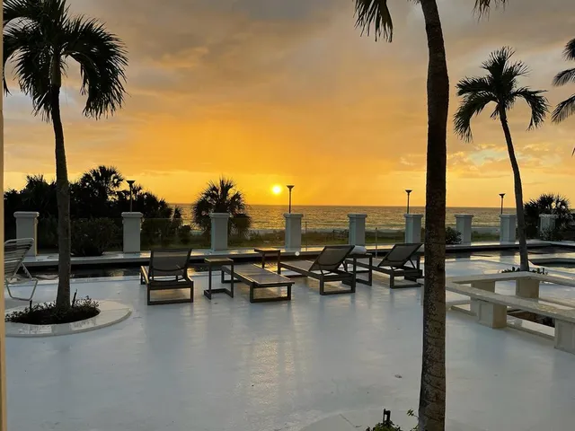 a living room with furniture a rug and a large window