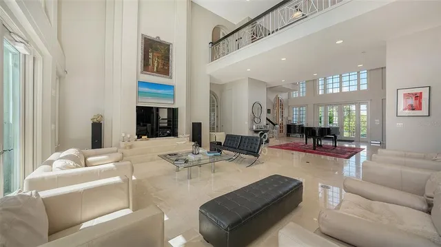 a living room with furniture and a floor to ceiling window