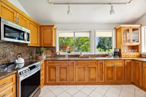 a kitchen with stainless steel appliances a stove sink and cabinets