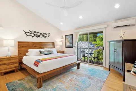 a bedroom with a large bed and a window