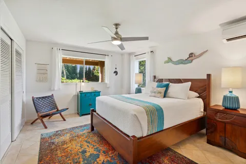 a bedroom with a bed a chair and a chandelier