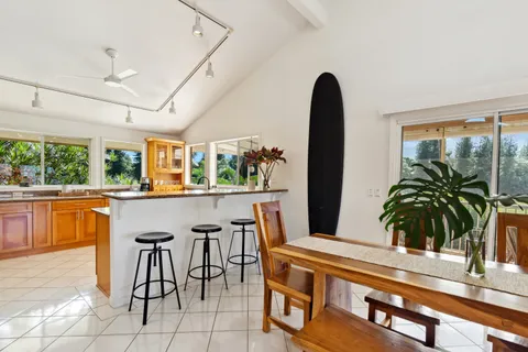 a dining room with a large window and furniture