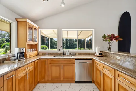a kitchen with a sink and large window