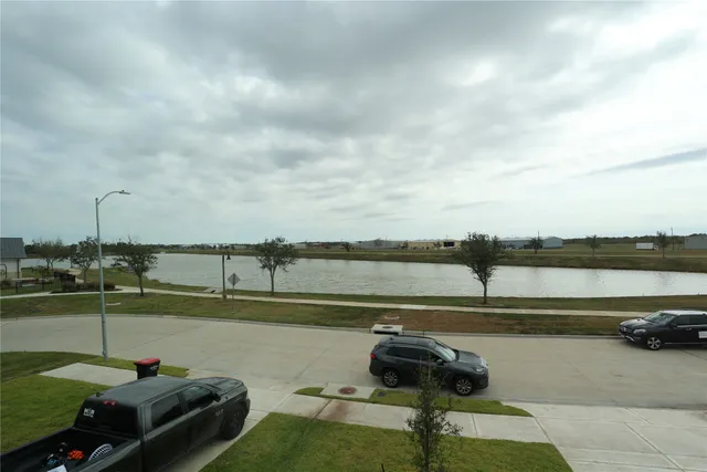 a view of a lake with a table and chairs