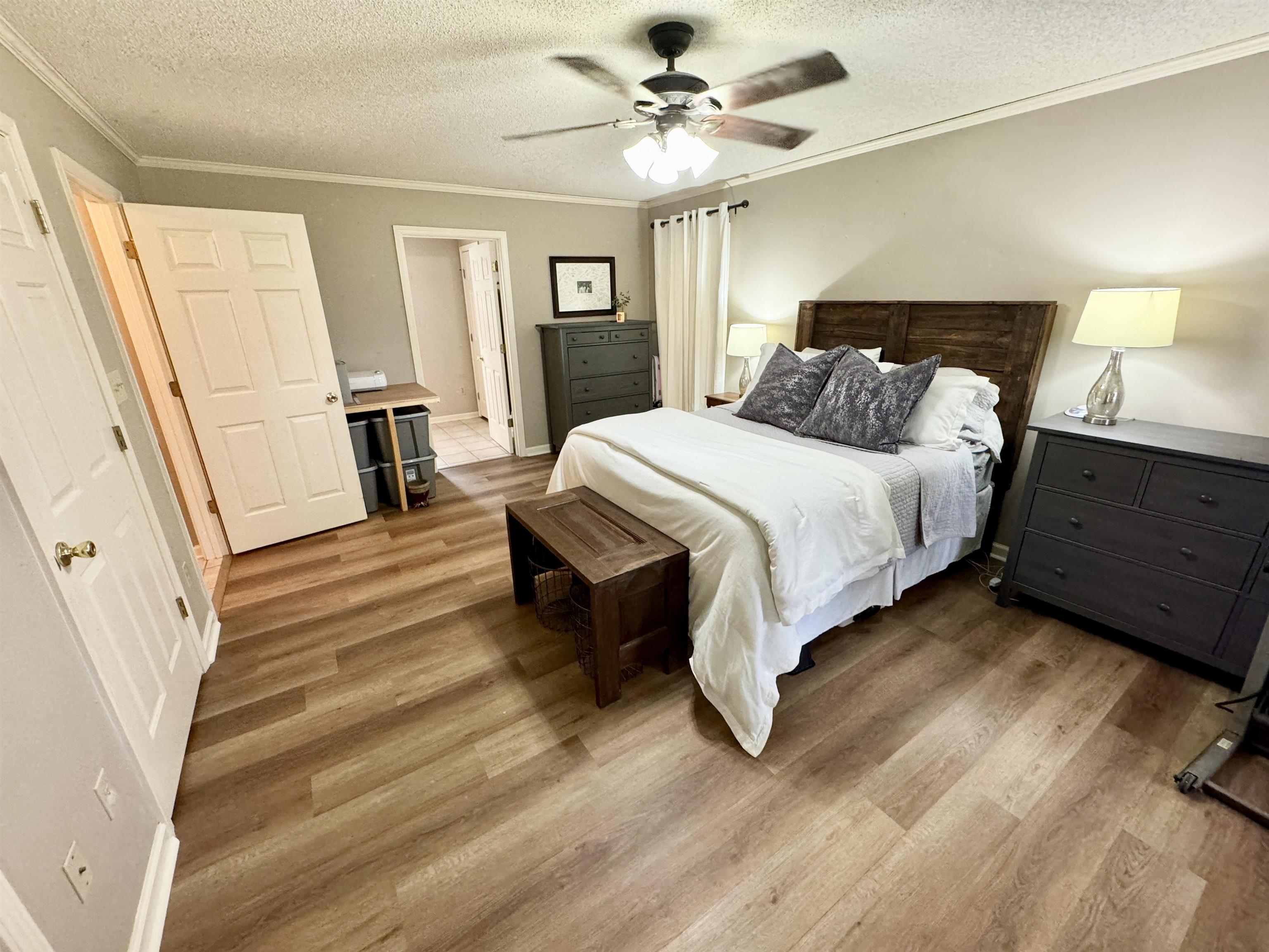 47 Chisholm Lake Road Ripley, TN 38063 - Photo 13 of 26 a spacious bedroom with a bed and a chandelier
