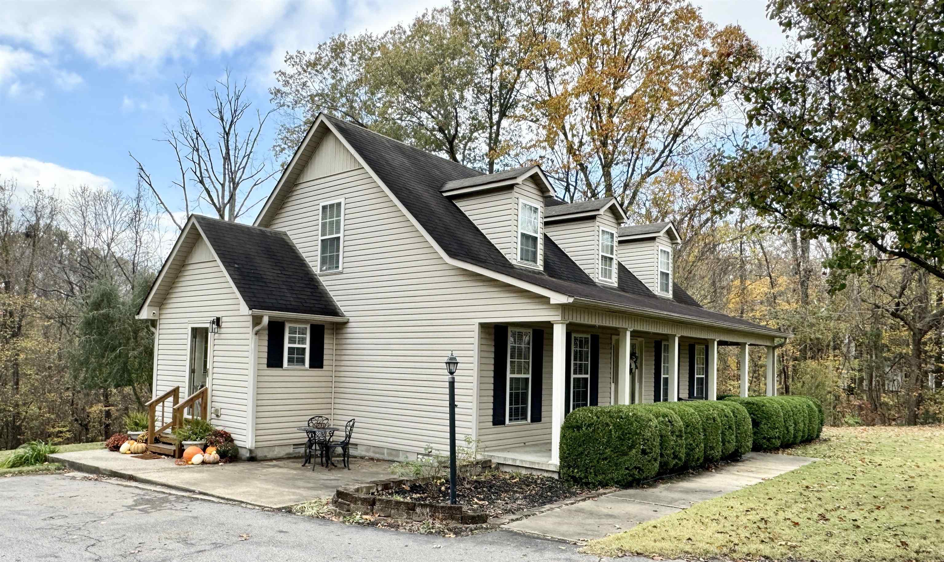 47 Chisholm Lake Road Ripley, TN 38063 - Photo 25 of 26 a front view of a house with a yard and potted plants