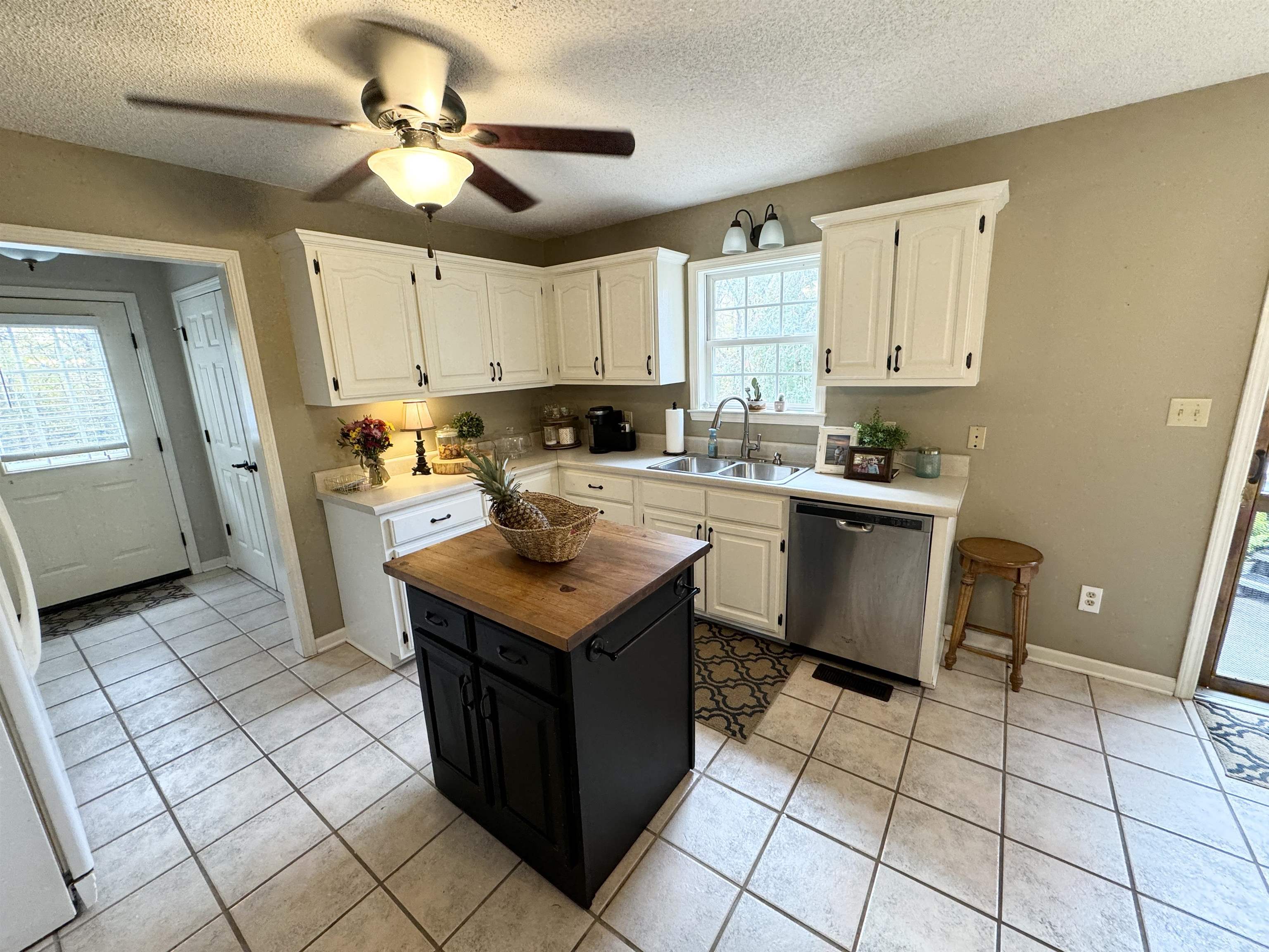 47 Chisholm Lake Road Ripley, TN 38063 - Photo 10 of 26 a kitchen with a sink a stove cabinets and a window