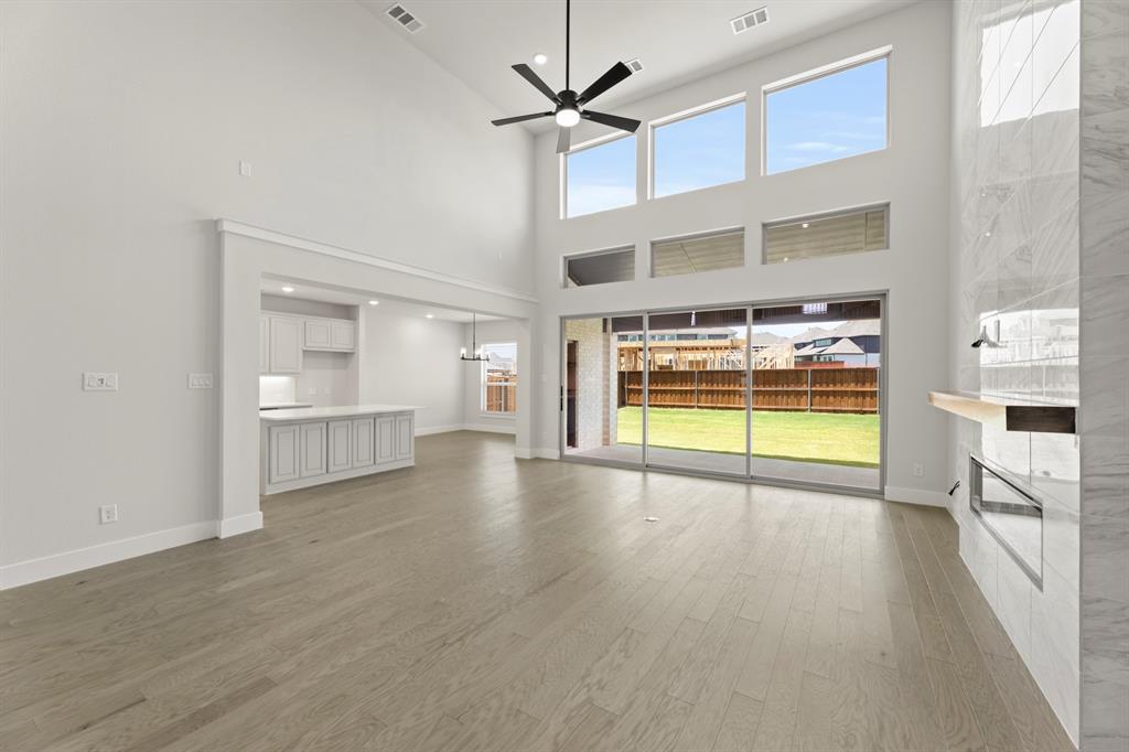 4213 Bellview Way Celina, TX 75009 - Photo 11 of 29 a view of an empty room with a window and a kitchen