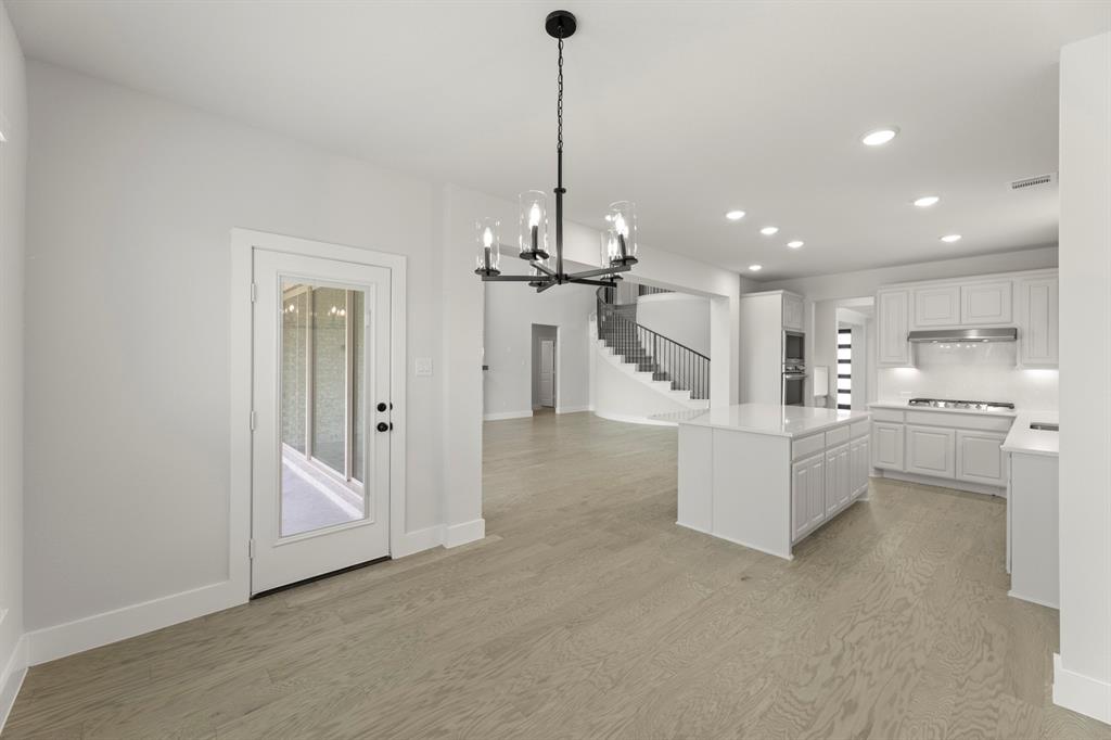 4213 Bellview Way Celina, TX 75009 - Photo 14 of 29 a view of a kitchen with refrigerator and white cabinets