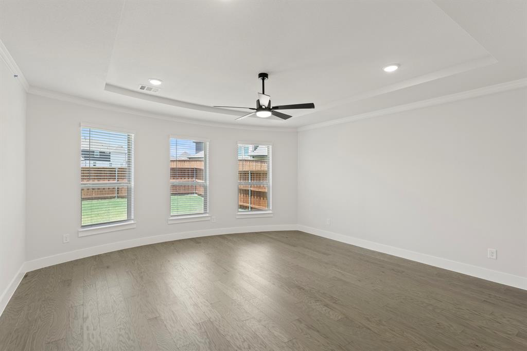 4213 Bellview Way Celina, TX 75009 - Photo 15 of 29 an empty room with wooden floor chandelier and windows