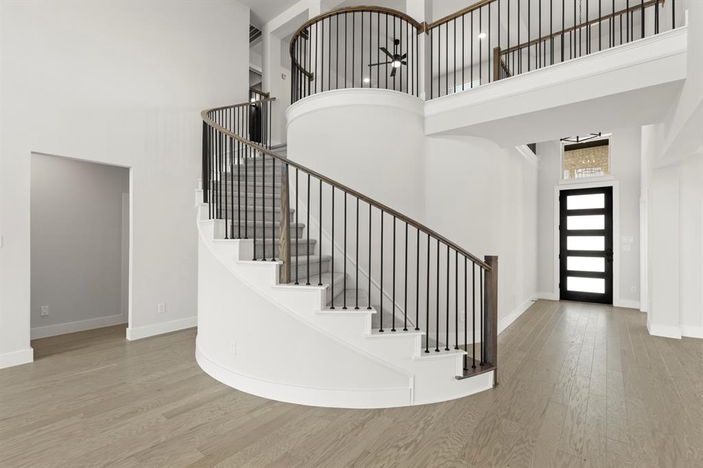 4213 Bellview Way Celina, TX 75009 - Photo 3 of 29 a view of staircase with wooden floor and white walls