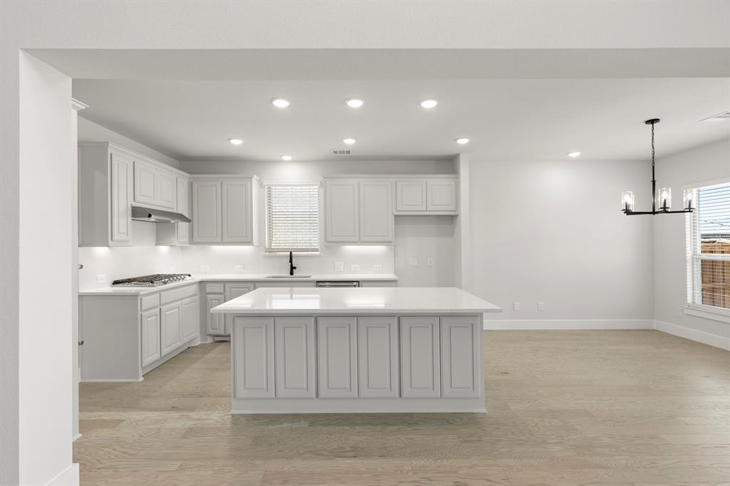 4213 Bellview Way Celina, TX 75009 - Photo 7 of 29 a kitchen with a sink stainless steel appliances and cabinets