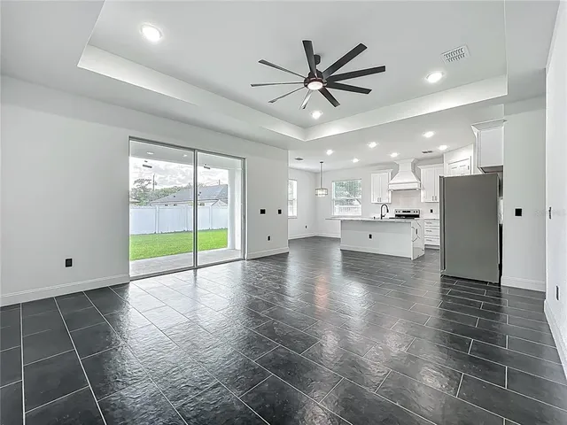 a view of a kitchen with a sink and a large window