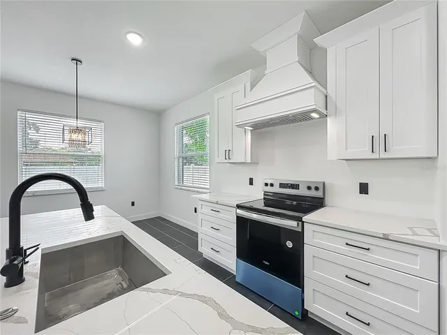 a kitchen with cabinets appliances and a sink
