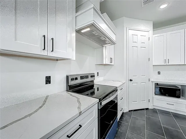 a kitchen with a sink and a stove