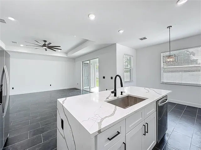 a kitchen that has a sink and a stove in it