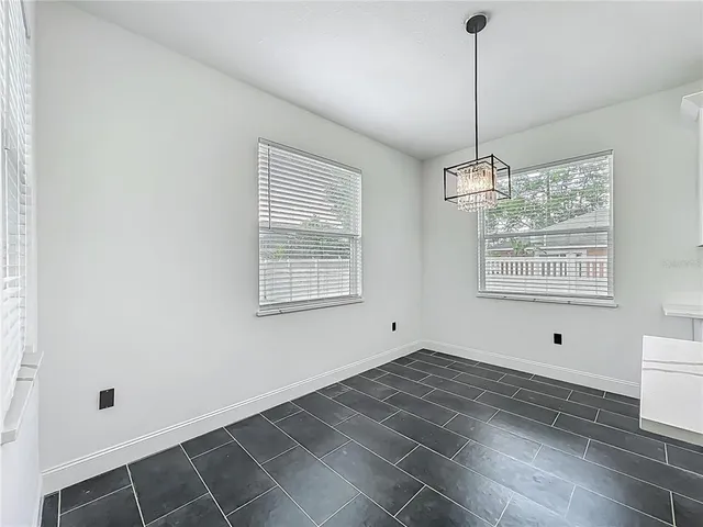 a bathroom with a granite countertop sink and a toilet
