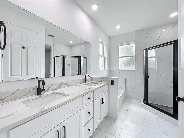 a bathroom with double vanity sink and a mirror