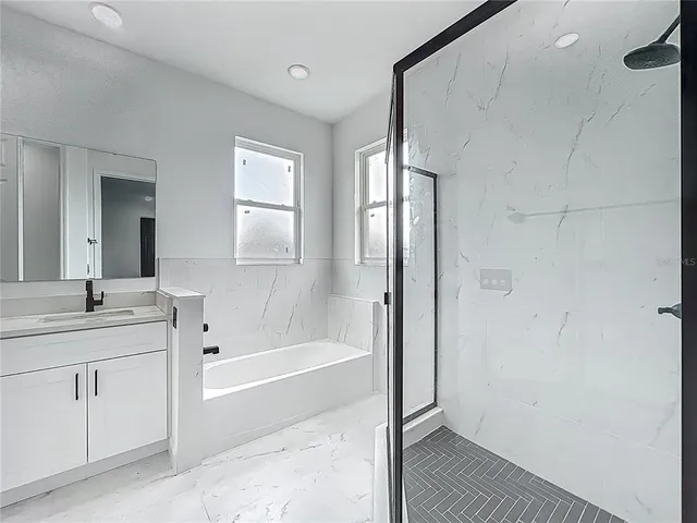 a bathroom with a granite countertop toilet and a shower