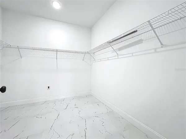 a view of a room with wooden floor and windows