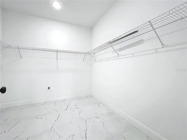 a view of a room with wooden floor and windows