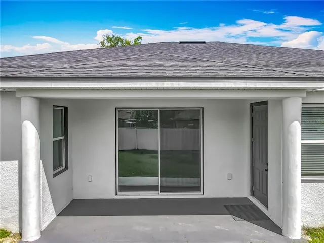 a view of a house with a yard and a garage