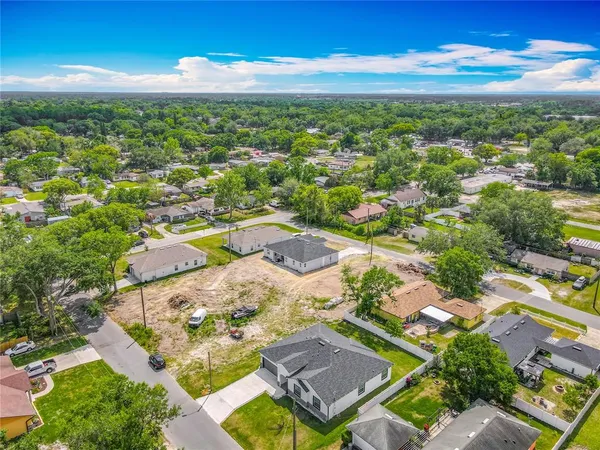 an aerial view of residential houses with outdoor space