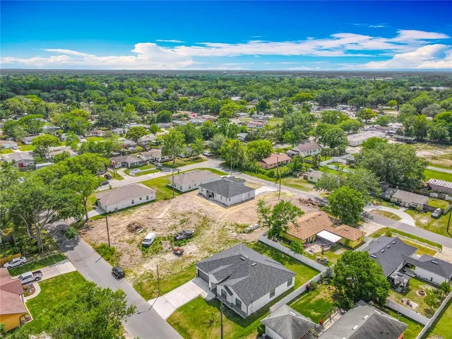 an aerial view of residential houses with outdoor space