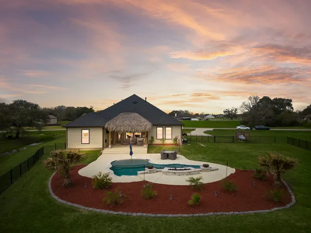 a view of a house with yard and lake view