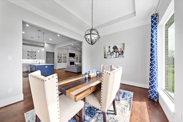 a dining room with furniture a rug and a chandelier