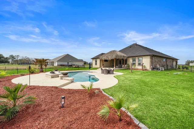 a view of a house with swimming pool and a yard