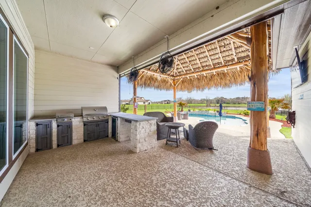 a view of a patio with a dining table and chairs