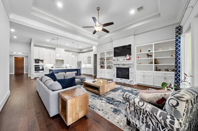 a living room with furniture flat screen tv and a fireplace