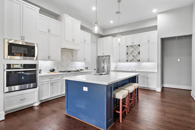 a kitchen with a sink cabinets and wooden floor
